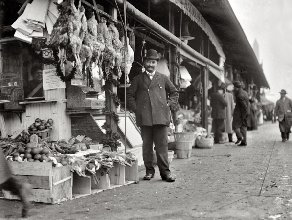 Photo showing: The Smiling Grocer -- Washington, D.C., circa 1915. P.K. Chaconas at his grocery (fancy fruits and vegetables), 924 Louisiana Avenue N.W.