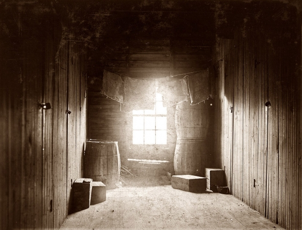 Photo showing: Into the Light -- Sept. 29, 1910. Upper-floor hallway opening onto 12 rooms in large shack
occupied by cranberry pickers on Forsythe's Bog. Turkeytown, near Pemberton, N.J.