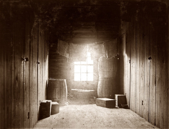 Photo showing: Into the Light -- Sept. 29, 1910. Upper-floor hallway opening onto 12 rooms in large shack
occupied by cranberry pickers on Forsythe's Bog. Turkeytown, near Pemberton, N.J.