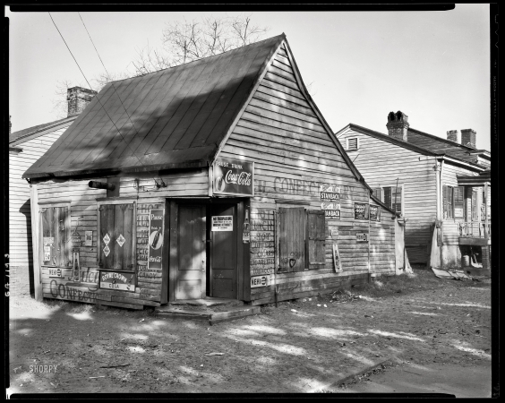 Photo showing: Closed Confectionery -- Savannah, Georgia circa 1940. Fahm Street row houses built c.1850. Torn down 1940 for Yamacraw Village housing.