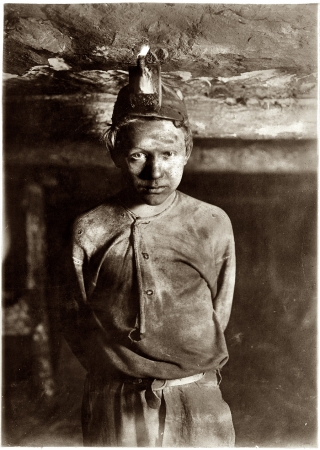 Photo showing: Trapper Boy -- October 1908. Trapper Boy, Turkey Knob Mine, Macdonald, West Virginia.
Boy had to stoop on account of low roof, photo taken more than a mile inside the mine.