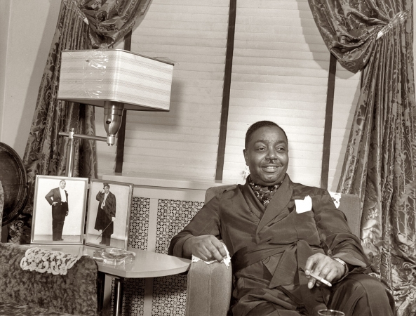 Photo showing: Big Joe Turner -- The Boss of the Blues was also a rock pioneer, the first to record Shake, Rattle and Roll. In his Chicago home, 1941.