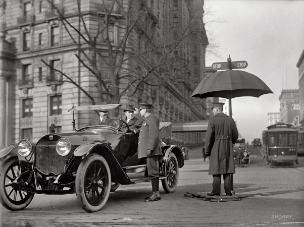 Photo showing: What Stop Sign? -- Washington, D.C. 1913. Traffic Stop and Go signs at 14th Street and Pennsylvania Avenue.