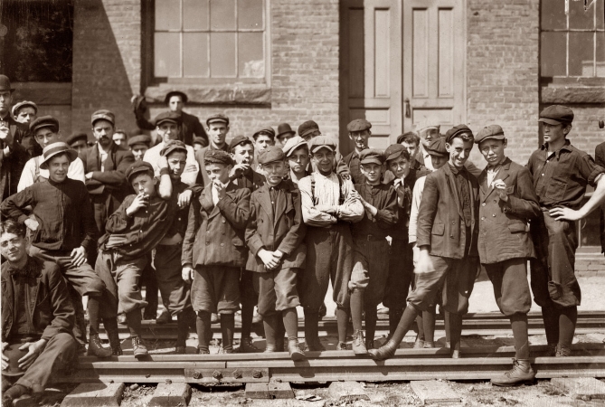 Photo showing: Indian Manufacturing -- September 1911. Young workers in front of Indian Mfg. Co., Indian Orchard, Mass.