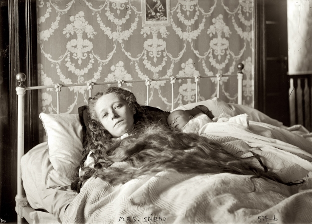 Photo showing: Ocey Snead (1) -- Mrs. Ocey Snead, in bed, baby in arms, December 1907 or January 1908.