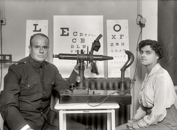 Photo showing: At First Sight: 1916 -- Preparing to examine an employee in the U.S. Treasury Dept. to determine the effect of work on the eyes.