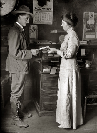 Photo showing: Scout Savers -- Gordon F. Chance, Boy Scout patrol leader, purchasing Postal Savings stamps, 1913.