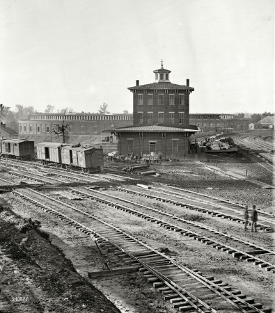 Photo showing: Atlanta Depot: 1864 -- November 1864. Railroad yards at Atlanta. The Roundhouse. Ruins of depot, blown up on Sherman's departure.