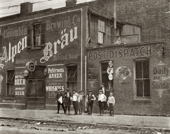 Photo showing: Johnstons Branch Newsies -- St. Louis, Missouri. May 1910. Newsies. Johnston's Branch adjoining Saloon at 10th & Cass Street. 