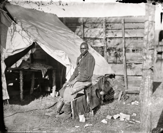 Photo showing: John Henry: 1863 -- October 1863. Bealeton, Virginia. John Henry, servant, at headquarters, 3d Army Corps, Army of the Potomac.