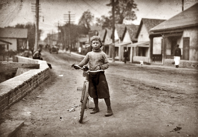 Photo showing: De Whole Show -- Waco, Texas. November 1913. Isaac Boyett: I'm de whole show. The 12-year-old proprietor, manager and messenger of the Club Messenger Service, 402 Austin Street. The photo shows him in the heart of the Red Light district.