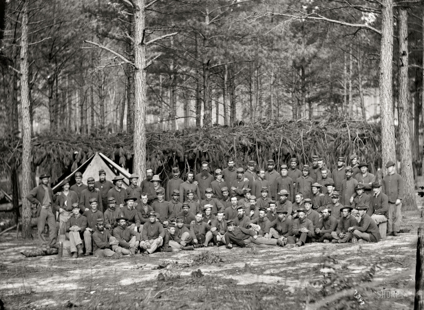 Photo showing: Company D -- August 1864. Group of men of Company D, U.S. Engineer Battalion, in front of Petersburg.