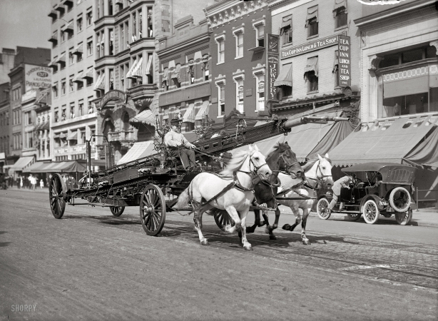 Photo showing: Galloping to the Fire -- Fire truck racing past the Tea Cup Inn on F Street, Washington D.C. circa 1914.