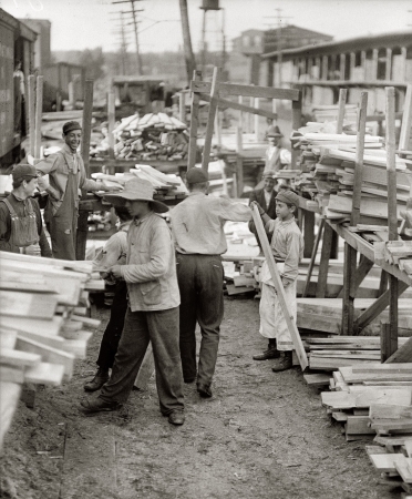 Photo showing: Planks a Lot -- September 1910. Boys working for Hickok Lumber Company. Burlington, Vermont.