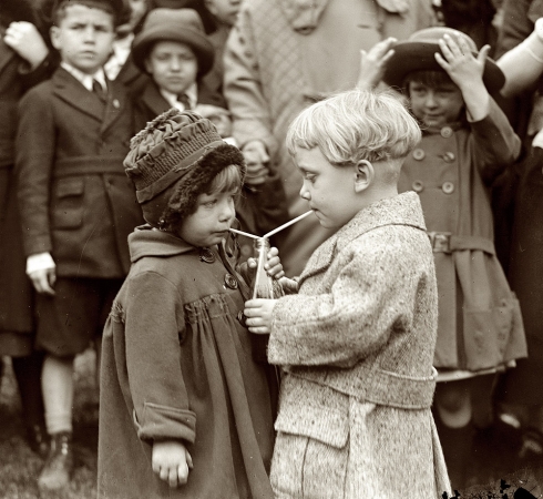 Photo showing: Sharesies: 1922 -- Fifty-fifty - something better than rolling Easter eggs. Sharing a drink at the White House Easter-egg roll.