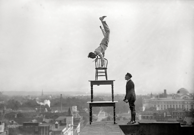 Photo showing: Table This Motion -- Washington, D.C., 1917. Jug Reynolds performing atop the Lansburgh furniture store on Ninth Street N.W.