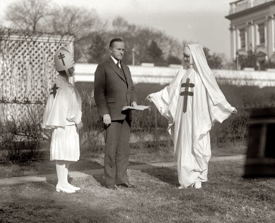 Photo showing: Coolidge Keeping Cool -- President Coolidge buying Christmas seals in 1923 to benefit the Tuberculosis Association.