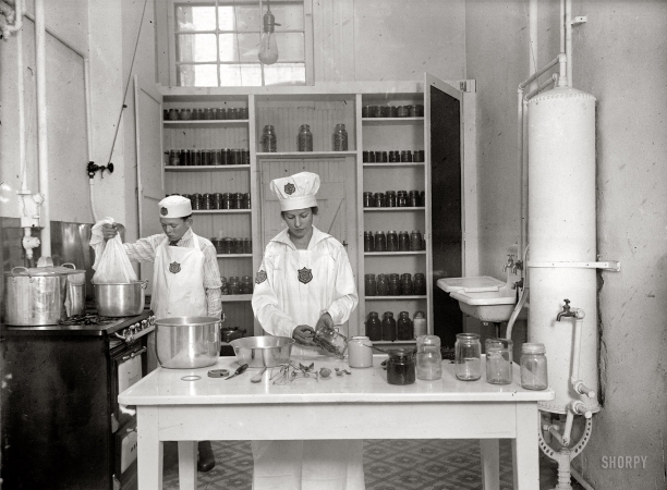 Photo showing: The Joy of Canning -- Department of Agriculture, Washington, D.C., circa 1917. Two young people wearing 4-H patches.