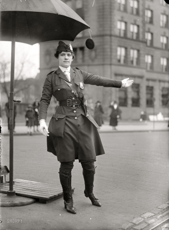 Photo showing: Drive This Way -- Washington, D.C., circa 1918. Mrs. L.O. King, traffic cop.