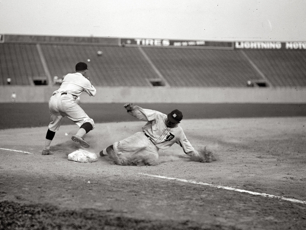 Photo showing: Ty Cobb Slides -- Aug. 16, 1924, at Griffith Stadium in Washington. Nationals and Tigers. Ty Cobb safe at third after making a triple.