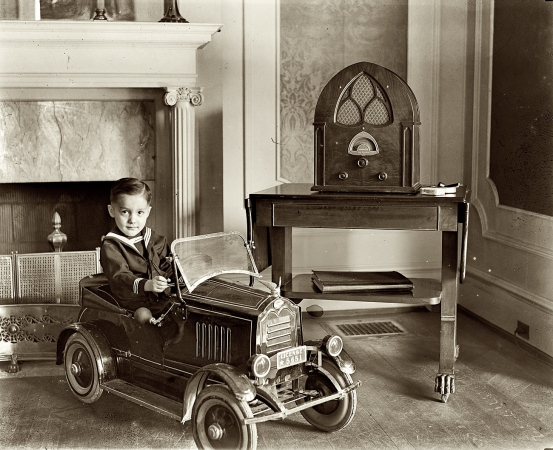 Photo showing: Car, Radio -- Washington, D.C., circa 1931. Child seated in toy automobile.