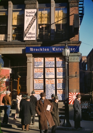 Photo showing: Yesterdays News. -- December 1940. Brockton, Mass. Men and a woman reading headlines
posted in window of Brockton Enterprise newspaper office on Christmas Eve.