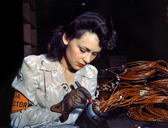 Photo showing: Electric Personality -- Checking aircraft electrical sub-assemblies, Lockheed Vega plant, Burbank, California, June 1942. 