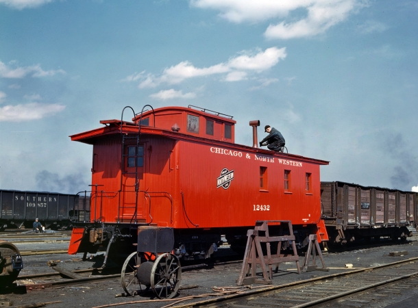 Photo showing: The Red Caboose -- Chicago, April 1943. Putting the finishing touches on a rebuilt caboose, Chicago & North Western RR Proviso Yard.