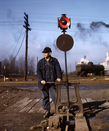 Photo showing: Switchman Dan -- Daniel Senise throwing a switch in an Indiana Harbor Belt Line railyard. February 1943.