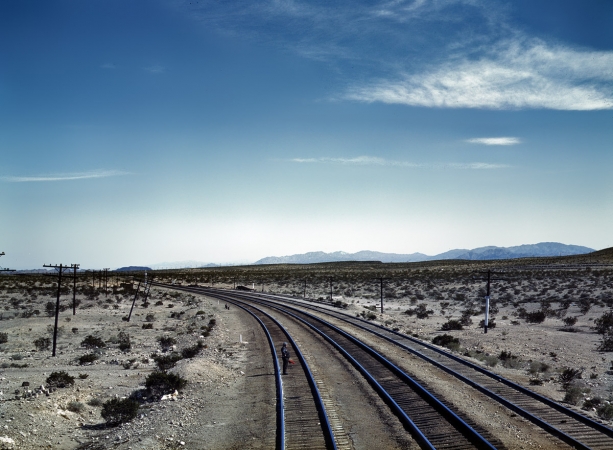 Photo showing: Bagdad Flagman -- Flagman behind a Santa Fe R.R. westbound freight during a stop at Bagdad, Calif. March 1943.