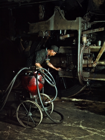 Photo showing: Jumbo-Lube -- Thomas Madrigal greasing a locomotive in the roundhouse, Rock Island R.R., Blue Island, Ill. April 1943.