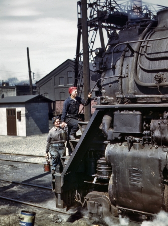 Photo showing: Working on the Railroad -- April 1943. Clinton, Iowa. Wipers for the Chicago & North Western RR, cleaning one of the giant H-class locomotives.