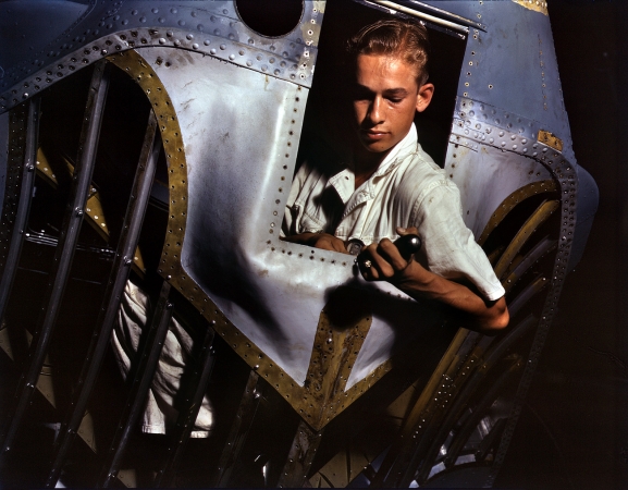 Photo showing: Trainee: 1942 -- Corpus Christi, Texas. Working inside the nose of a PBY, Elmer J. Pace is learning the construction of Navy planes.