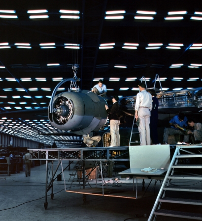 Photo showing: Assembling Aircraft: 1942 -- Lowering an engine into place, transport assembly hall, Consolidated Aircraft plant, Fort Worth, Texas.