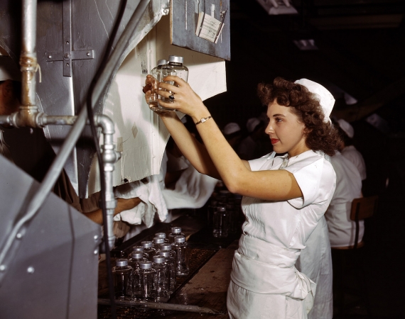 Photo showing: Wartime Work Solution -- October 1942. Glenview, Illinois. Transfusion bottles containing intravenous solution are given final inspection.