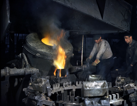 Photo showing: Casting a Billet: 1942 -- Modern electric furnaces speeding the production of brass and other copper alloys for national defense.