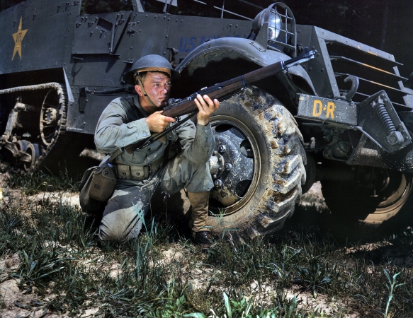 Photo showing: Taking Aim -- June 1942. Fort Knox, Kentucky. A young soldier sights his Garand rifle like an old-timer.