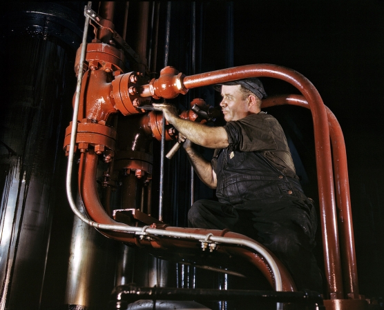 Photo showing: Red Pipes -- June 1942. Chattanooga, Tenn. Combustion Engineering worker and world's largest cold steel hydraulic press.