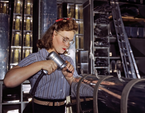Photo showing: Wingwoman: 1942 -- Inglewood, California. North American Aviation drill operator assembling horizontal stabilizer section of an airplane.