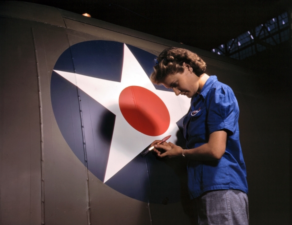 Photo showing: Big Wartime Star -- February 1943. Touching up the insignia on a Vengeance dive bomber, at Consolidated-Vultee's Nashville division.