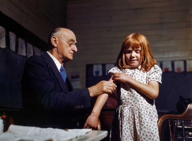 Photo showing: This Won't Hurt a Bit -- Dr. Schreiber gives a typhoid inoculation at a rural school in San Augustine County, Texas, 1943.