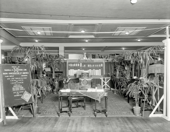 Photo showing: A Radiola for Every Purse: 1925 -- Radio Corporation of America exhibit including the RCA Radiola 104, Radiola Super VIII and Radiola IIIA. Also, palms.