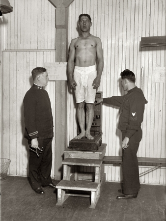 Photo showing: Step Right Up -- New York, 1917. Examination on Recruit. Inductee gets weighed aboard the landship in Union Square.