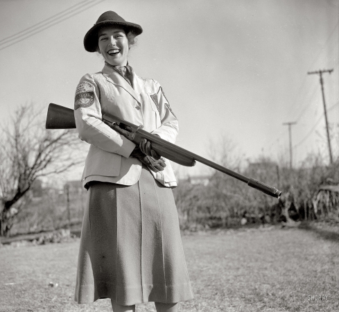 Photo showing: Armed and Delighted -- January 5, 1938. Westmoreland Hills, Maryland. Mrs. Albert F. Walker, 1937 women's skeet shooting champion. 