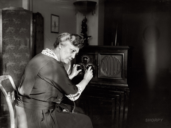 Photo showing: Mrs. New Tunes In -- January 14, 1924. Mrs. Harry S. New, wife of the Postmaster General.