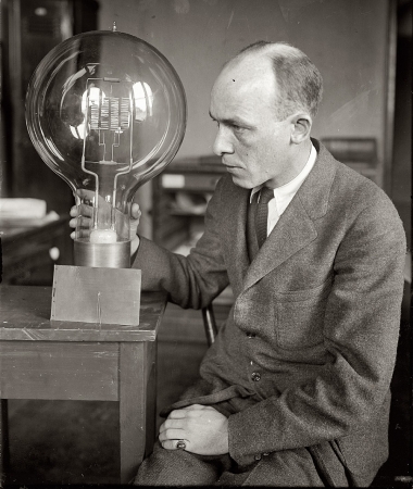 Photo showing: A Big Idea -- Washington, D.C. March 12, 1925. C.W. Mitman of Smithsonian Institution with giant and midget bulbs.