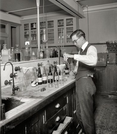 Photo showing: Reverse Mixologist -- Washington, D.C., circa 1920. U.S. Treasury, Internal Revenue Department.
Measuring the alcohol content of various libations and tonics at the start of Prohibition.