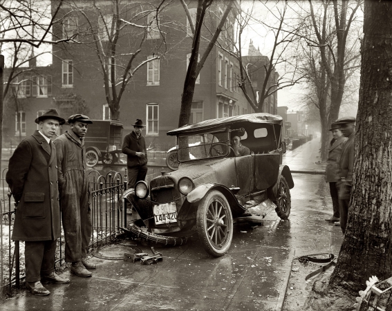 Photo showing: Wrong Turn -- 1921. Auto wreck. Vehicular mishap on the streets (and sidewalks) of Washington, D.C.