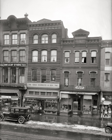 Photo showing: Seventh Street Stores -- Washington, D.C. 1921. Flanking Chas. Schwartz & Sons Co. jeweler: footwear from small to large, and a palmist-medium.