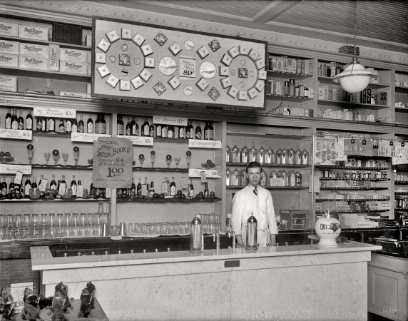 Photo showing: Soda Jerk -- Washington, D.C., circa 1921. People's Drug store, 31st & M Streets N.W., soda fountain.